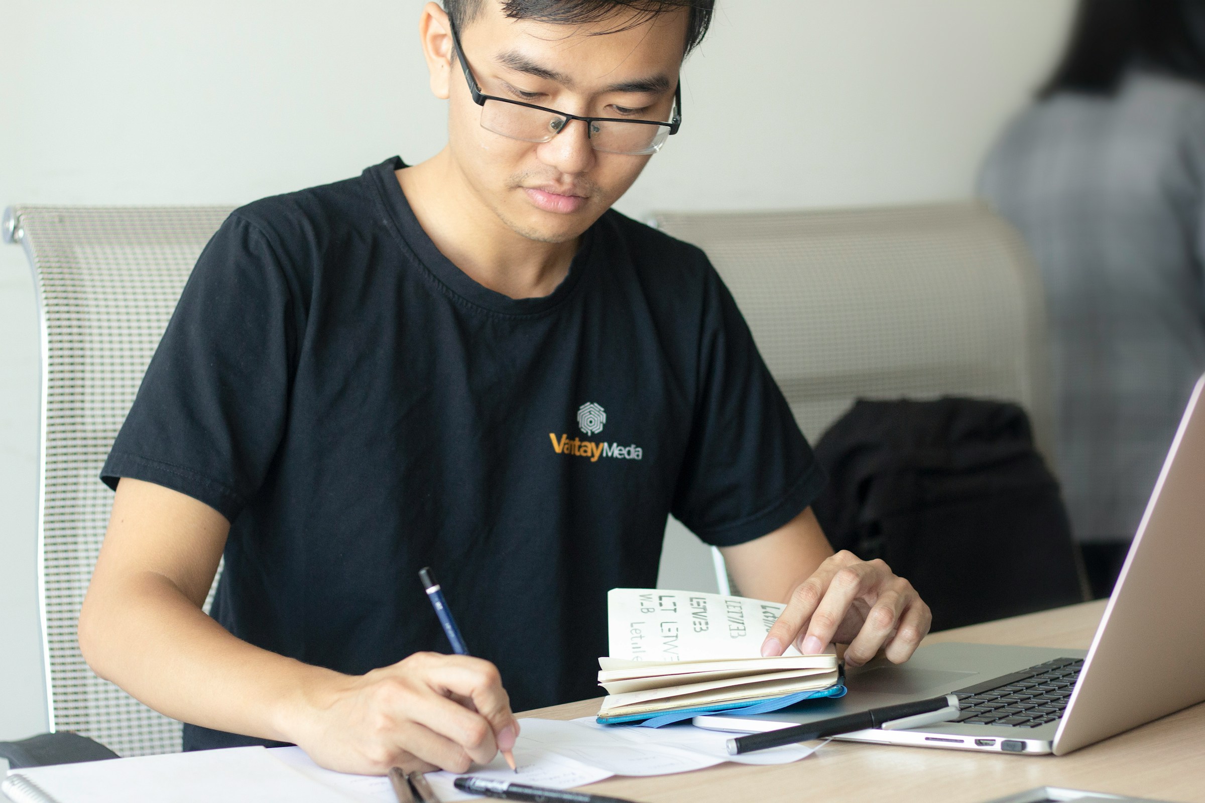 A day trader calculating a trade with pen and paper